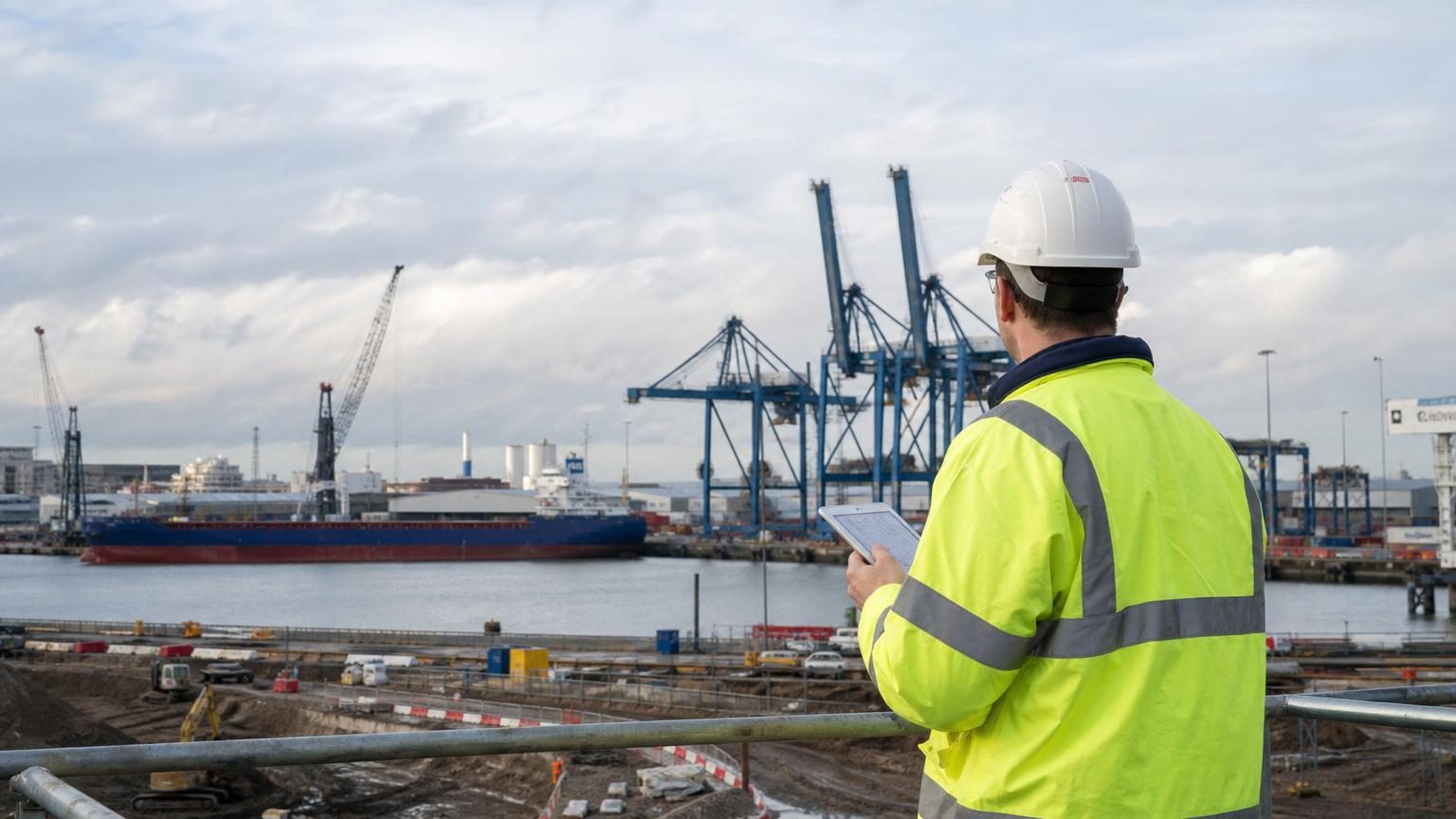 Container cranes at a UK port during sunset