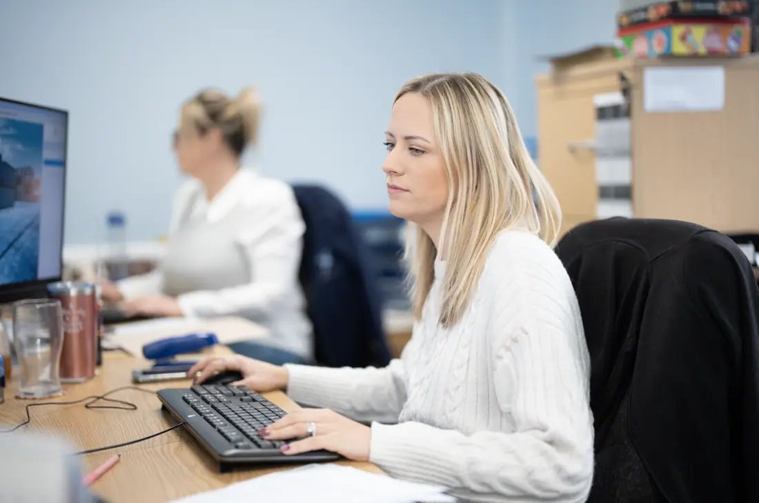 Jenkar team member working at her desk