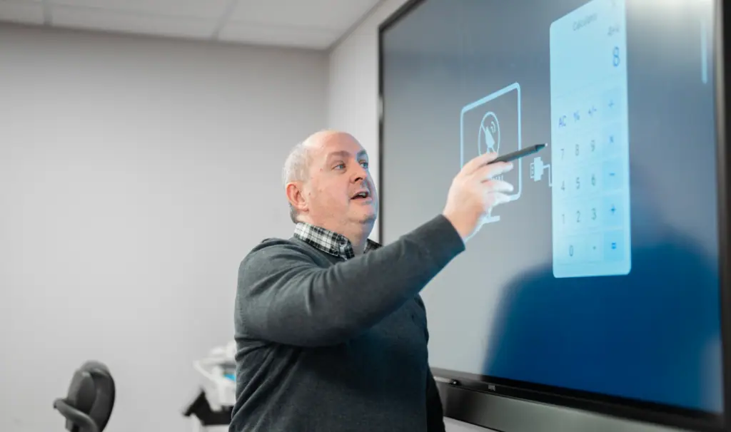Jenkar team member presenting at an interactive screen