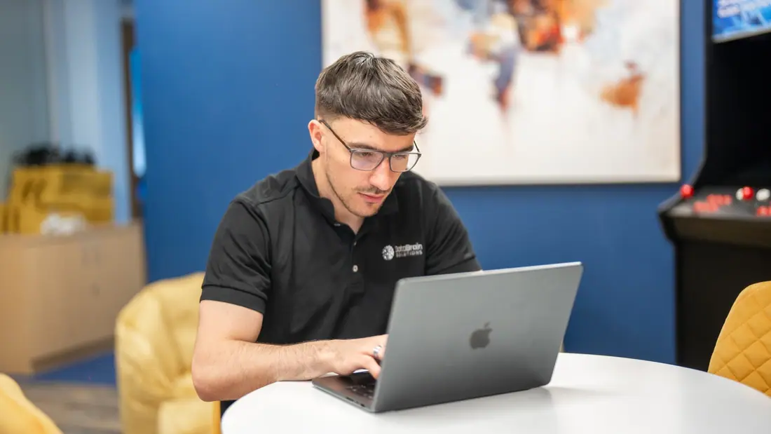 Jenkar team member working on a laptop