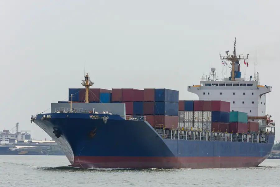 Ship loaded with containers travelling through sea